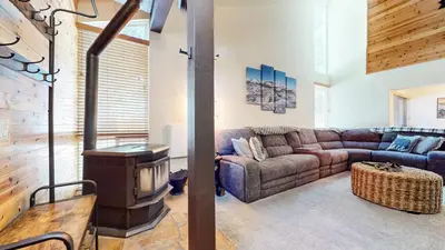 a living room with a couch and a stove at Sierra Park Road #150 condo in Mammoth Lakes