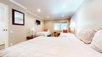a bedroom with a large white bed and two chairs at Lakeview Villas #27 condo in Mammoth Lakes