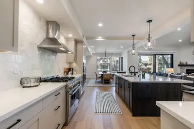 a large kitchen with white cabinets and a large island at Crestwood at Schaffer's Mill in Truckee
