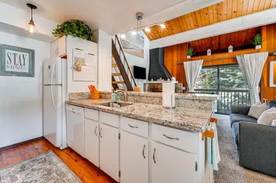 a kitchen with a sink and a refrigerator at 1 Mi to Lake Tahoe Condo with Pool Access in Kings Beach