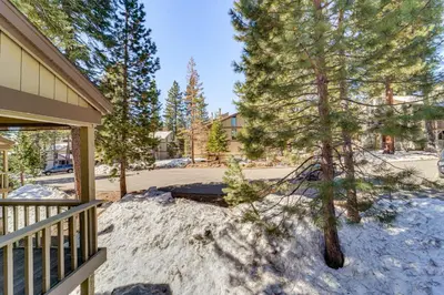 a yard with snow on the ground next to a house at 1 Mi to Lake Tahoe Condo with Pool Access in Kings Beach