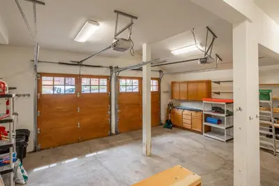 a garage with two brown doors and wooden cabinets at Northstar - Northstar Vista in Truckee
