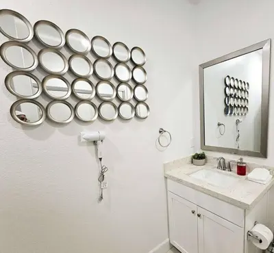 a bathroom with a sink and a mirror at Couple's Getaway Kitchenette Washer & Private Bath in Lincoln Village