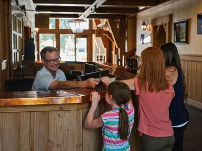 a group of people standing around a bar at The Cottages - Ski Shuttle, Ski Valet - 3-Bedroom in Truckee