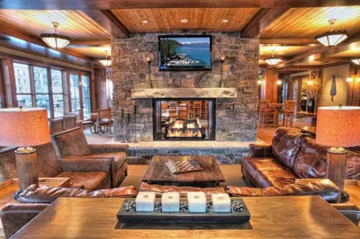 a large living room with a stone fireplace at The Cottages - Ski Shuttle, Ski Valet - 3-Bedroom in Truckee
