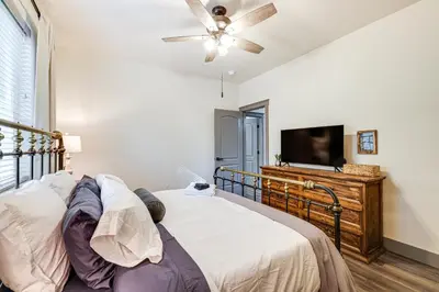a bedroom with a bed and a flat screen tv at Game Room and Patio Picturesque Home in Sonora in Sonora