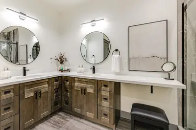 a bathroom with two sinks and two mirrors at Game Room and Patio Picturesque Home in Sonora in Sonora