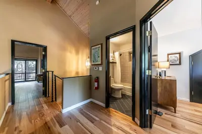 a hallway of a house with a bathroom and a toilet at Raven Retreat at Tahoe Donner - 3 BR w Forest Views! in Truckee