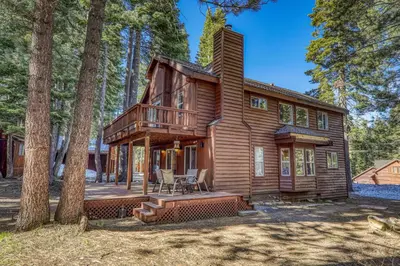 a wooden house with a porch and a deck at Raven Retreat at Tahoe Donner - 3 BR w Forest Views! in Truckee