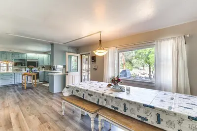 a kitchen and dining room with a table and a window at Beautiful Kernville Home with Game Room and Mtn Views! in Kernville