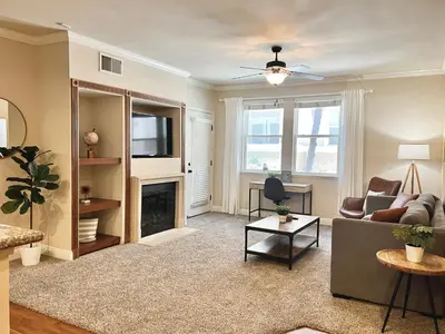 a living room with a couch and a fireplace at Relaxing 2-BR Apt with Pool Hot Tub Gym and Basketball Court Access in Reno