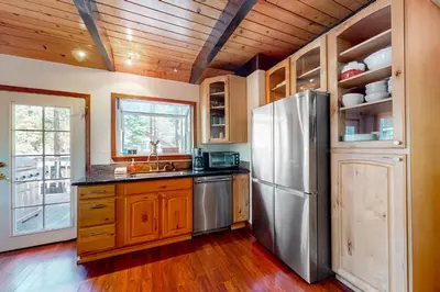 a kitchen with a stainless steel refrigerator and wooden cabinets at Mountain Escape in South Lake Tahoe