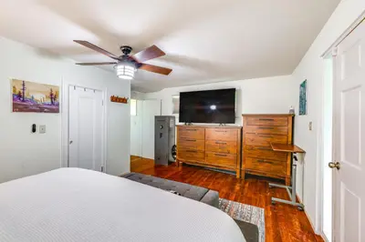 a bedroom with a bed and a flat screen tv at On-Site River Access Quiet Home in Wilseyville! in Wilseyville