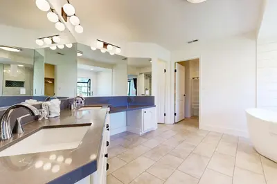 a bathroom with a sink and a large mirror at Fair Days on the Fairway in Groveland