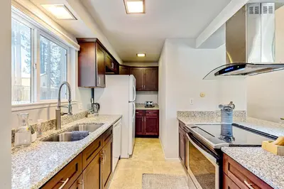 a kitchen with a sink and a refrigerator at Sierra Tranquility in Incline Village