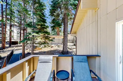 a balcony with chairs and a table and trees at Sierra Tranquility in Incline Village