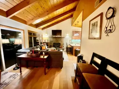a living room with a couch and a table at Newly Renovated Family Lake House, Private Beach! in Tahoma