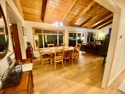 a dining room with a table and chairs at Newly Renovated Family Lake House, Private Beach! in Tahoma