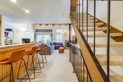 a kitchen and living room with a staircase and a living room at Steps to Lake Scenic Carnelian Bay Retreat in Carnelian Bay