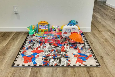 a table with toys on top of a rug at Spacious Family Home in Stockton - Pets Welcome! in Stockton
