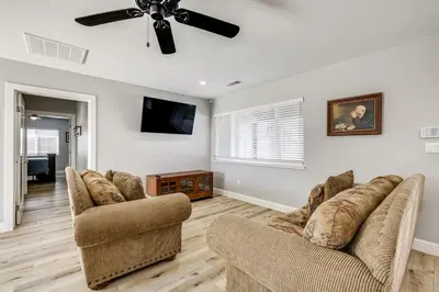 a living room with two couches and a ceiling fan at Quaint Hughson Vacation Rental, Walk to Downtown! in Hughson