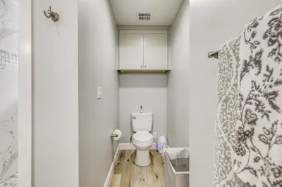 a small bathroom with a toilet and a shower at Quaint Hughson Vacation Rental, Walk to Downtown! in Hughson