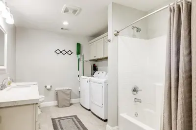 a white bathroom with a washer and dryer at Pet-Friendly Hughson Getaway, 9 Mi to Modesto! in Hughson