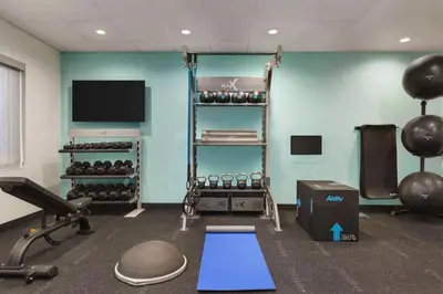 a room with a gym with weights and a tv at Tru By Hilton Lodi in Lodi