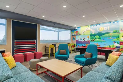 a childrens waiting room with a pool table and chairs at Tru By Hilton Lodi in Lodi
