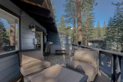 a porch with two chairs and a table on a house at 3BR with Hot Tub 1 Mile to Diamond Peak in Incline Village