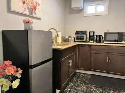 a kitchen with a refrigerator and a microwave at Spacious 2Beds Suite Close to Downtown and UC Davis Medical Center in Sacramento