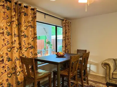 a dining room with a table and chairs and a window at Spacious 2Beds Suite Close to Downtown and UC Davis Medical Center in Sacramento