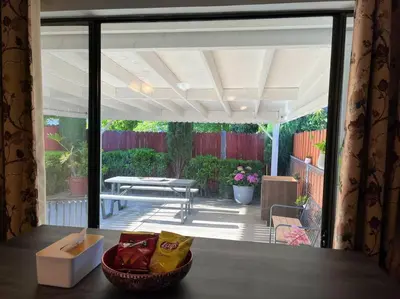 a screened in porch with a table and a patio at Spacious 2Beds Suite Close to Downtown and UC Davis Medical Center in Sacramento