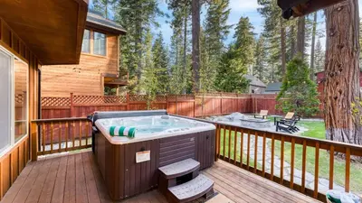 a hot tub on the deck of a house at Washoe Chalet by AvantStay Game Room Hot Tub Putting Green Fire Pit in Tahoma