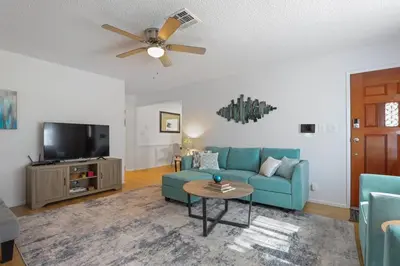 a living room with a blue couch and a tv at Trinity Escape Entire home near Lodi Lake in Lodi