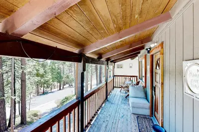 a porch of a house with a blue chair on it at The Venado House in Arnold