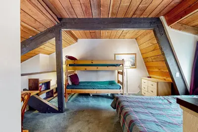 a bedroom with two bunk beds in a attic at Bigwood 54 K in Mammoth Lakes