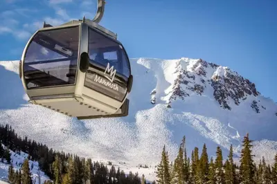 a gondola is flying over a snow covered mountain at Bigwood 54 K in Mammoth Lakes