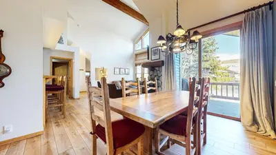 a dining room and living room with a wooden table at Snowcreek V #874 condo in Mammoth Lakes