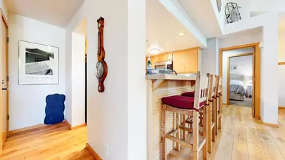 a kitchen and dining room with a bar with a stool at Snowcreek V #874 condo in Mammoth Lakes