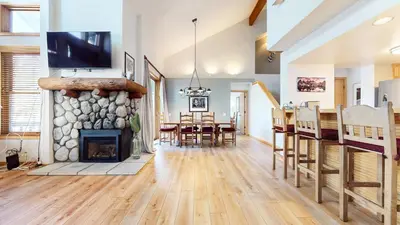 a living room with a fireplace and a dining room at Snowcreek V #874 condo in Mammoth Lakes