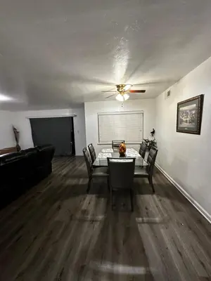 a living room with a table and chairs and a couch at Casa Relajante in Visalia