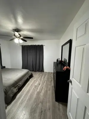 a bedroom with a bed and a ceiling fan at Casa Relajante in Visalia
