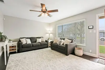 a living room with two couches and a ceiling fan at Robert St Cottage, near Lodi Lake in Lodi