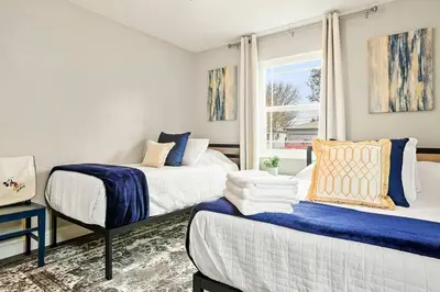 a bedroom with two beds and a window at Robert St Cottage, near Lodi Lake in Lodi
