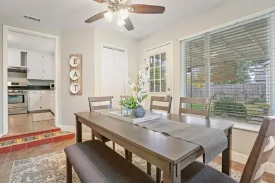 a kitchen and dining room with a table and chairs at Robert St Cottage, near Lodi Lake in Lodi
