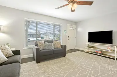 a living room with a couch and a flat screen tv at Robert St Cottage, near Lodi Lake in Lodi