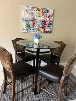 a glass table with chairs and a vase on top at Serene 2bed 1bath condo with parking in Fresno