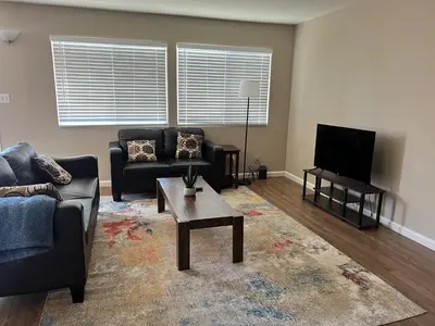 a living room with a couch and a tv at Serene 2bed 1bath condo with parking in Fresno