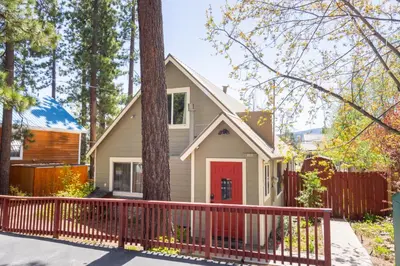 a house with a red door and a fence at Fern Grove - Hot Tub, Pet Friendly, Walk to Lake! in Tahoe City
